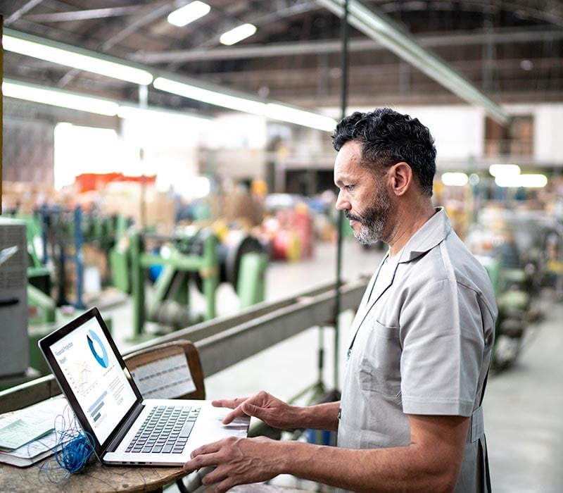 man using manufacturing software on laptop